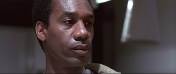 Movie still from “Terminator 2: Judgment Day” (1991), directed by James Cameron – A man's face with water on his face; Close Up shot, Low angle