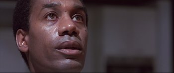 Movie still from “Terminator 2: Judgment Day” (1991), directed by James Cameron – A man's eyes and face; Close Up shot, Low angle