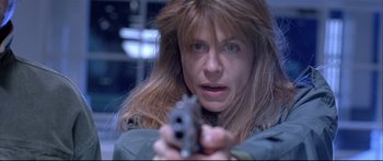 Movie still from “Terminator 2: Judgment Day” (1991), directed by James Cameron – A person holding a gun; Close Up shot, High angle