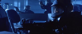 Movie still from “Terminator 2: Judgment Day” (1991), directed by James Cameron – A person with a gas mask on in a dark room; Close Up shot, Low angle