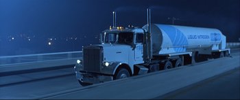 Movie still from “Terminator 2: Judgment Day” (1991), directed by James Cameron – A semi truck driving down a highway at night; Wide shot, Low angle