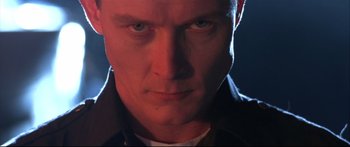 Movie still from “Terminator 2: Judgment Day” (1991), directed by James Cameron – A man's face in the dark; Close Up shot, Low angle