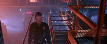 Movie still from “Terminator 2: Judgment Day” (1991), directed by James Cameron – A police officer walking down a set of stairs at night; Medium shot, Low angle