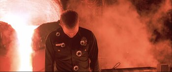 Movie still from “Terminator 2: Judgment Day” (1991), directed by James Cameron – A man with bullet holes on his shirt; Close Up shot, Low angle