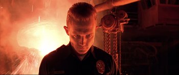 Movie still from “Terminator 2: Judgment Day” (1991), directed by James Cameron – A man in a police uniform looking at the camera; Close Up shot, Low angle