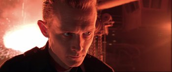 Movie still from “Terminator 2: Judgment Day” (1991), directed by James Cameron – A person wearing a suit and tie; Close Up shot, Low angle