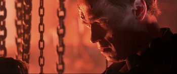 Movie still from “Terminator 2: Judgment Day” (1991), directed by James Cameron – A person with a chain in the background; Close Up shot, Low angle