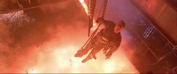 Movie still from “Terminator 2: Judgment Day” (1991), directed by James Cameron – A man hanging from chains in the middle of a room; Wide shot, Overhead angle
