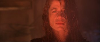 Movie still from “Terminator 2: Judgment Day” (1991), directed by James Cameron – A woman with long brown hair is looking at the camera; Close Up shot, Low angle
