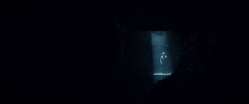 Movie still from “Terminator Genisys” (2015), directed by Alan Taylor – A man standing in the dark in front of a light; Extreme Wide shot, Low angle