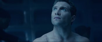 Movie still from “Terminator Genisys” (2015), directed by Alan Taylor – A man looking up into the sky with a blue light; Close Up shot, Low angle