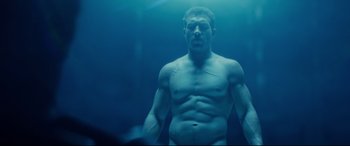 Movie still from “Terminator Genisys” (2015), directed by Alan Taylor – A man standing in the middle of a body of water; Medium shot, Low angle