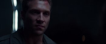 Movie still from “Terminator Genisys” (2015), directed by Alan Taylor – A person with a blood spot on his forehead; Close Up shot, Over the shoulder angle