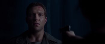 Movie still from “Terminator Genisys” (2015), directed by Alan Taylor – A man holding a gun in front of a mirror; Close Up shot, Over the shoulder angle