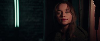 Movie still from “Terminator Genisys” (2015), directed by Alan Taylor – A young woman is standing in a dark room; Close Up shot, Over the shoulder angle