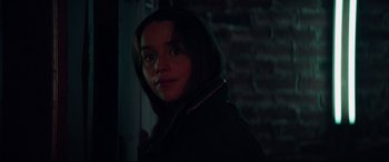 Movie still from “Terminator Genisys” (2015), directed by Alan Taylor – A young woman is standing in a dark room; Close Up shot, Over the shoulder angle