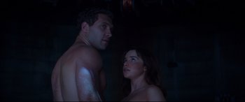 Movie still from “Terminator Genisys” (2015), directed by Alan Taylor – A man and a woman standing next to each other in the dark; Medium shot, Low angle
