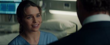Movie still from “Terminator Genisys” (2015), directed by Alan Taylor – A woman in a blue shirt is talking to a man in a hospital bed; Close Up shot, Over the shoulder angle