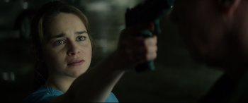 Movie still from “Terminator Genisys” (2015), directed by Alan Taylor – A woman is holding a gun in her hand; Close Up shot, Over the shoulder angle