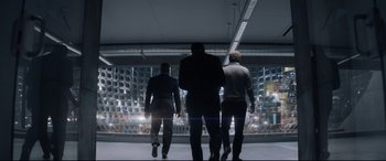 Movie still from “Terminator Genisys” (2015), directed by Alan Taylor – Three men are walking in a building at night; Wide shot, Low angle
