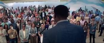 Movie still from “Terminator Genisys” (2015), directed by Alan Taylor – A group of people standing in front of an audience; Wide shot, Over the shoulder angle