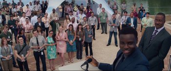 Movie still from “Terminator Genisys” (2015), directed by Alan Taylor – A group of people standing in a circle and a man is speaking; Wide shot, Over the shoulder angle