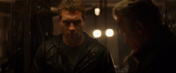 Movie still from “Terminator Genisys” (2015), directed by Alan Taylor – A man wearing a leather jacket standing next to another man; Close Up shot, Over the shoulder angle