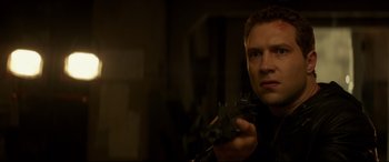 Movie still from “Terminator Genisys” (2015), directed by Alan Taylor – A person holding something in his hand; Close Up shot, Low angle