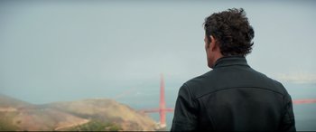 Movie still from “Terminator Genisys” (2015), directed by Alan Taylor – A man looking out at the golden gate bridge; Medium shot, Over the shoulder angle