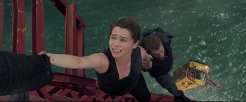 Movie still from “Terminator Genisys” (2015), directed by Alan Taylor – A woman and a man are climbing up a ramp; Medium shot, Overhead angle