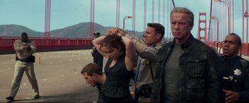 Movie still from “Terminator Genisys” (2015), directed by Alan Taylor – A group of people standing next to each other on a bridge; Medium shot, Low angle