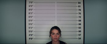 Movie still from “Terminator Genisys” (2015), directed by Alan Taylor – A woman standing in front of a wall with a lot of lines; Medium shot, Low angle