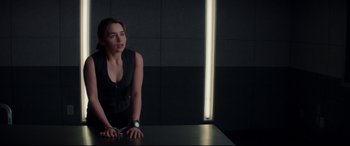 Movie still from “Terminator Genisys” (2015), directed by Alan Taylor – A woman standing in front of a table with lights; Medium shot, Over the shoulder angle