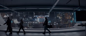 Movie still from “Terminator Genisys” (2015), directed by Alan Taylor – A man is walking in front of a large window; Extreme Wide shot, Low angle