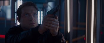 Movie still from “Terminator Genisys” (2015), directed by Alan Taylor – A man is holding a gun in his hand; Close Up shot, Low angle