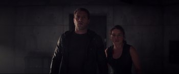 Movie still from “Terminator Genisys” (2015), directed by Alan Taylor – A man and a woman standing next to each other in the dark; Medium shot, Low angle