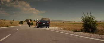 Movie still from “Texas Chainsaw Massacre” (2022), directed by David Blue Garcia – A police car parked on the side of the road; Extreme Wide shot, Low angle