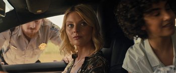Movie still from “Texas Chainsaw Massacre” (2022), directed by David Blue Garcia – A woman sitting in the back seat of a car; Close Up shot, Over the shoulder angle