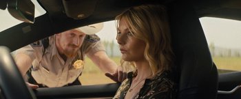 Movie still from “Texas Chainsaw Massacre” (2022), directed by David Blue Garcia – A woman sitting in the drivers seat of a car; Close Up shot, Over the shoulder angle