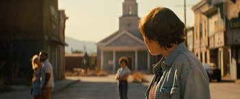 Movie still from “Texas Chainsaw Massacre” (2022), directed by David Blue Garcia – Two people standing in front of a building; Medium shot, Over the shoulder angle