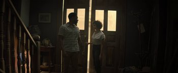 Movie still from “Texas Chainsaw Massacre” (2022), directed by David Blue Garcia – A man and a woman standing in front of a door; Medium shot, Over the shoulder angle