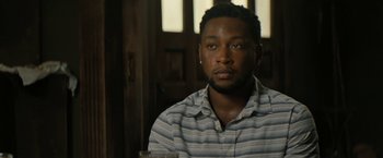 Movie still from “Texas Chainsaw Massacre” (2022), directed by David Blue Garcia – A person wearing a striped shirt; Close Up shot, Over the shoulder angle