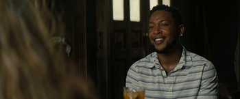 Movie still from “Texas Chainsaw Massacre” (2022), directed by David Blue Garcia – A man sitting at a table with a glass of orange juice in front of him; Close Up shot, Over the shoulder angle