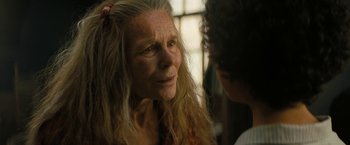 Movie still from “Texas Chainsaw Massacre” (2022), directed by David Blue Garcia – An older woman with long white hair talking to a young man; Close Up shot, Over the shoulder angle