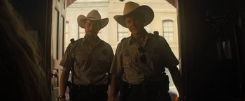 Movie still from “Texas Chainsaw Massacre” (2022), directed by David Blue Garcia – A couple of men in cowboy hats standing next to each other; Medium shot, Low angle