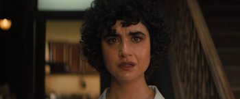 Movie still from “Texas Chainsaw Massacre” (2022), directed by David Blue Garcia – A person with curly black hair; Close Up shot, Over the shoulder angle