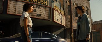 Movie still from “Texas Chainsaw Massacre” (2022), directed by David Blue Garcia – A person standing in front of a movie theater; Wide shot, Low angle