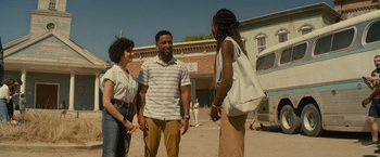Movie still from “Texas Chainsaw Massacre” (2022), directed by David Blue Garcia – A group of people standing next to each other on a street; Medium shot, Over the shoulder angle