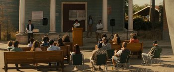 Movie still from “Texas Chainsaw Massacre” (2022), directed by David Blue Garcia – A group of people sitting in front of a podium; Wide shot, High angle