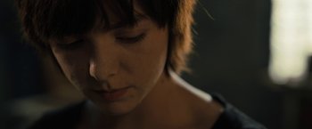 Movie still from “Texas Chainsaw Massacre” (2022), directed by David Blue Garcia – A woman's face in the dark; Close Up shot, High angle